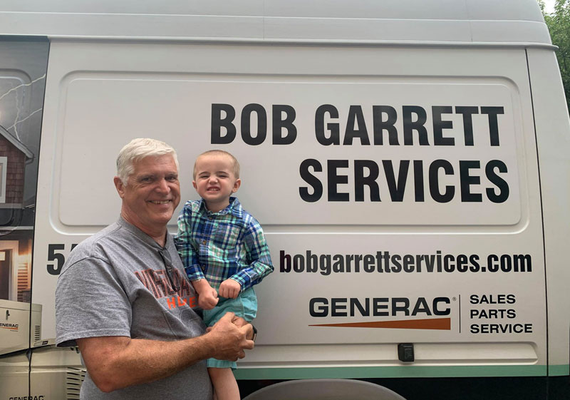 bob garrett and brayden in front of bob garrett services van