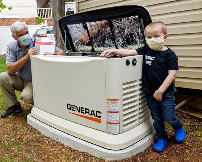bob garrett and braydan of bob garrett services in front of generac generator in roanoke virginia